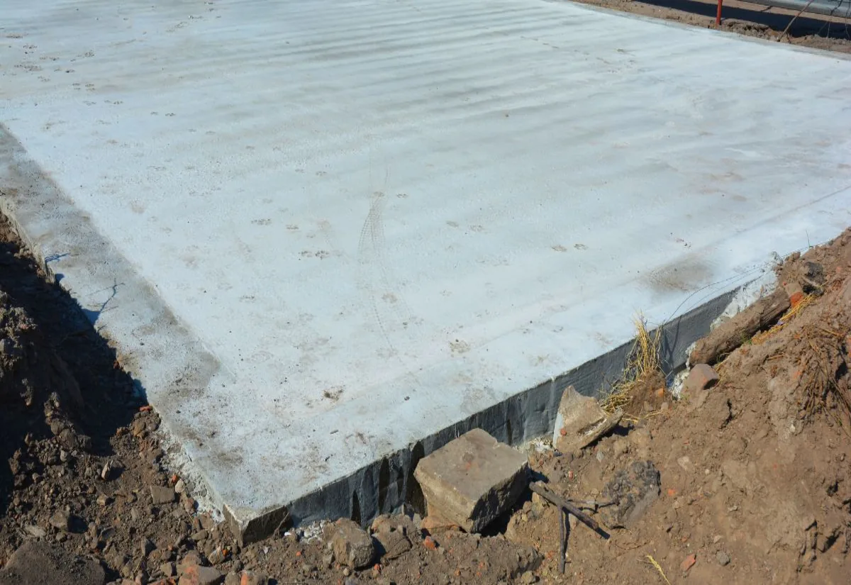 Bare concrete slab left behind after a small structure was removed